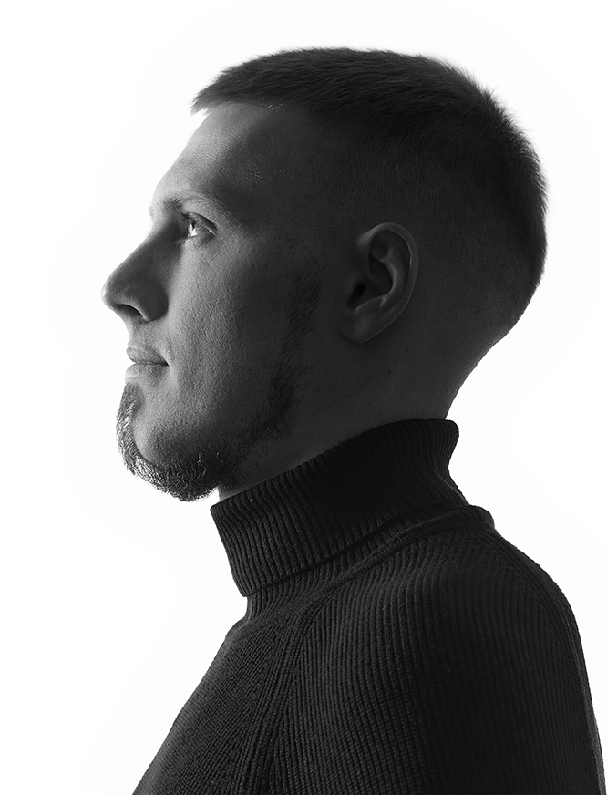 Роман Аносов - front-end web разработчик в чёрно белом цвете смотрит в сторону